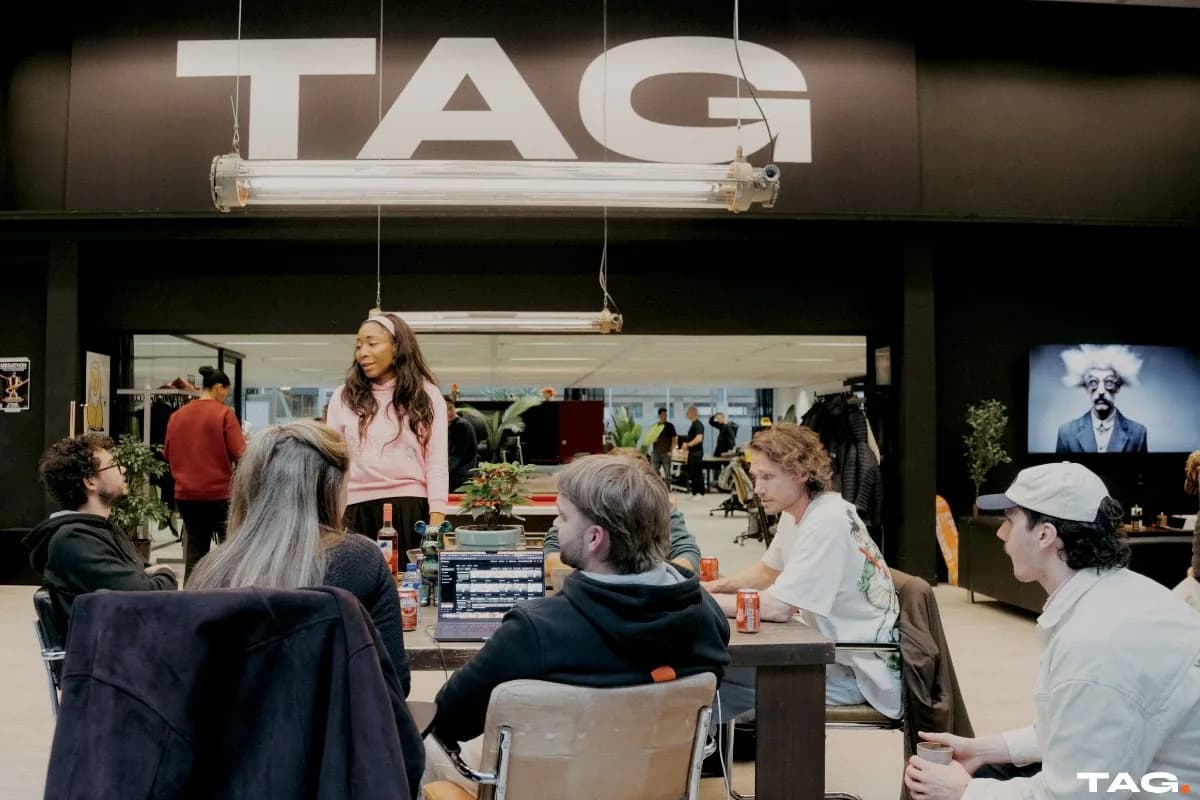 The TAG floor during the first Creative AI Hackathon, under the TAG sign